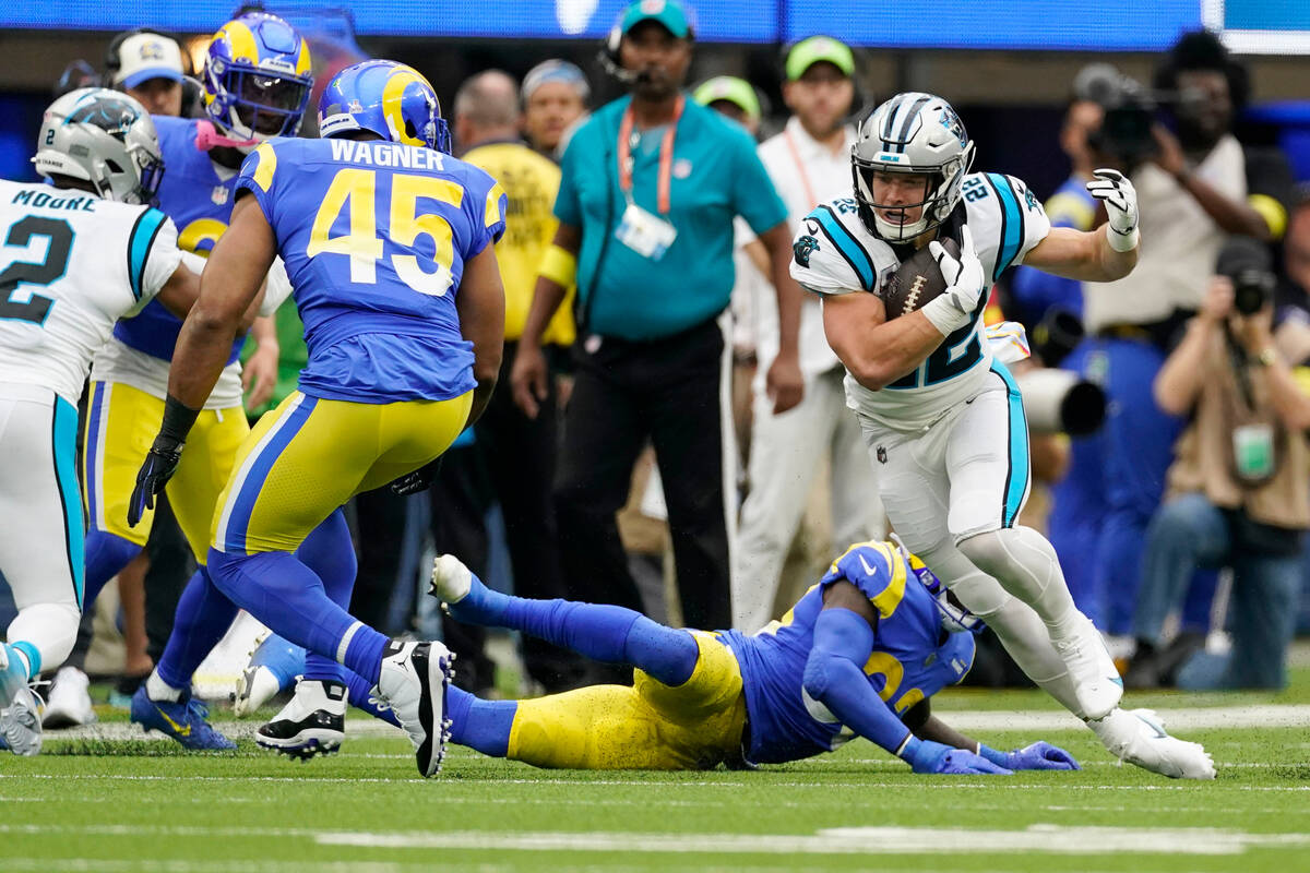 Carolina Panthers running back Christian McCaffrey, right, carries against the Los Angeles Rams ...