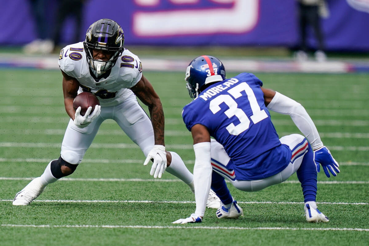 New York Giants' Fabian Moreau (37) falls down while covering Baltimore Ravens' Demarcus Robins ...
