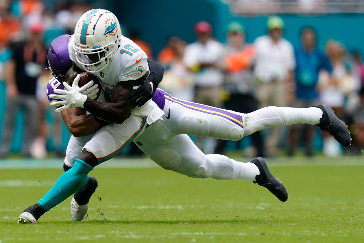Miami Dolphins wide receiver Tyreek Hill (10) gets tackled by Minnesota Vikings linebacker Jord ...