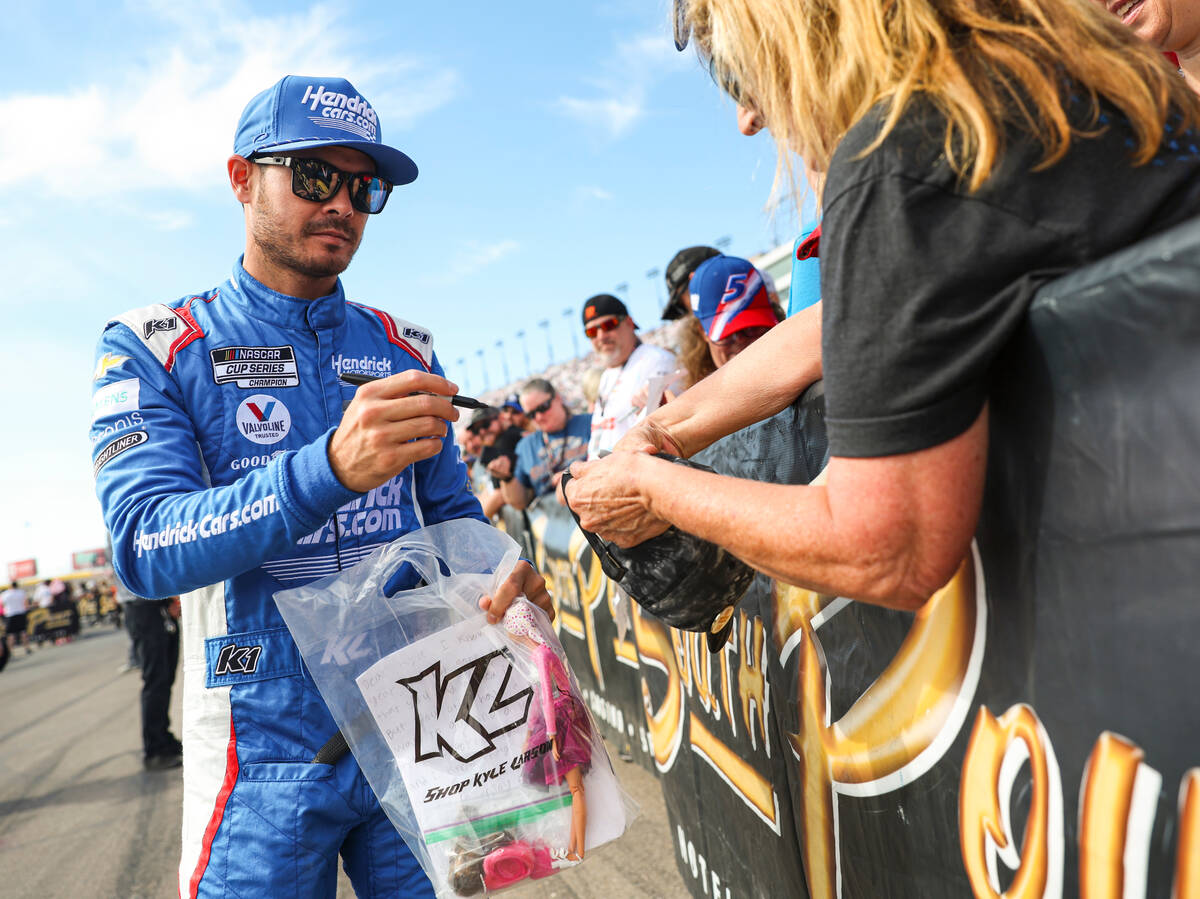 NASCAR Cup Series driver Kyle Larson signs items for fans before the start of the NASCAR Cup Se ...