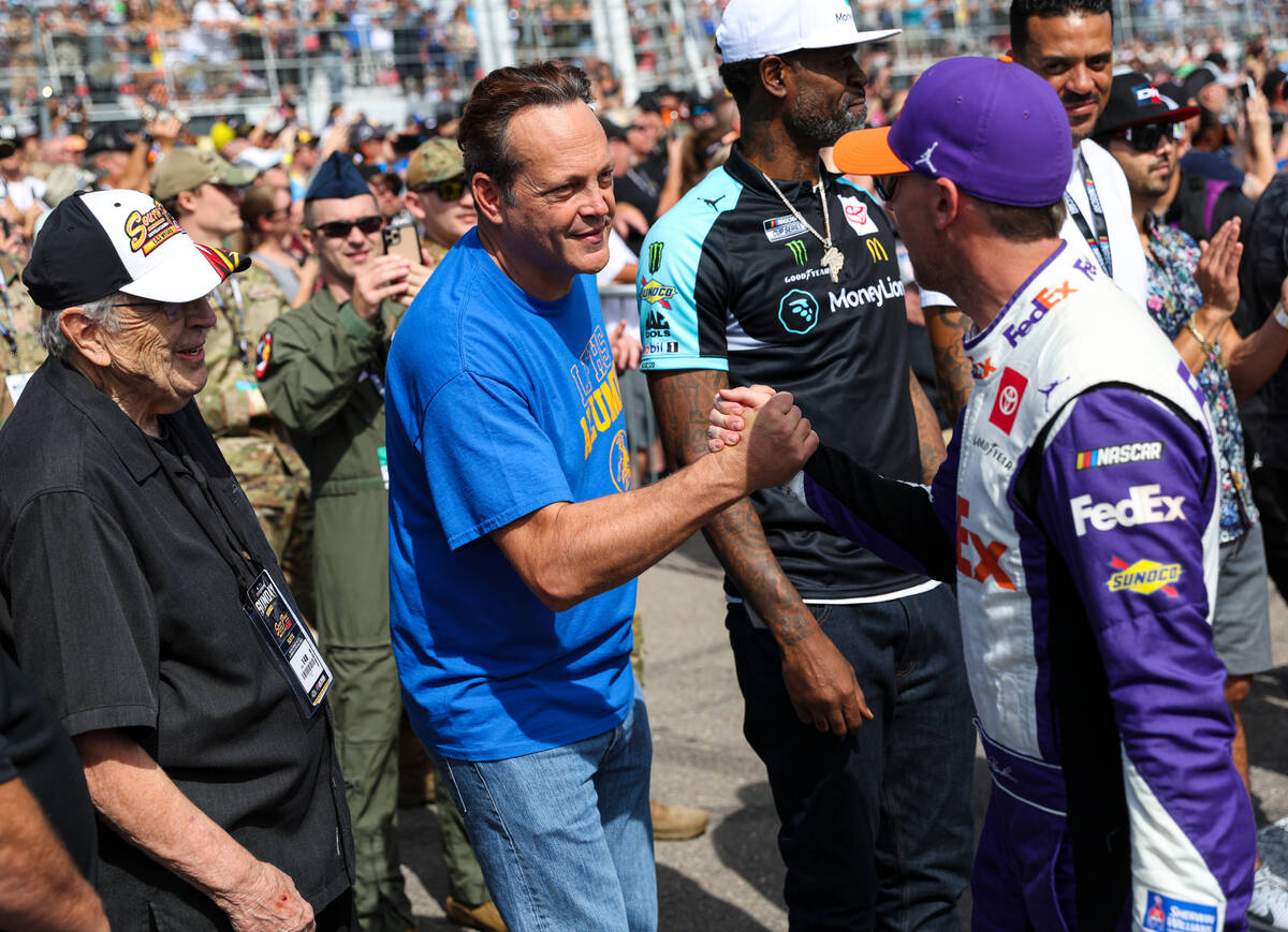 Actor Vince Vaughn greets driver Denny Hamlin (11) during the NASCAR Cup Series playoff race at ...