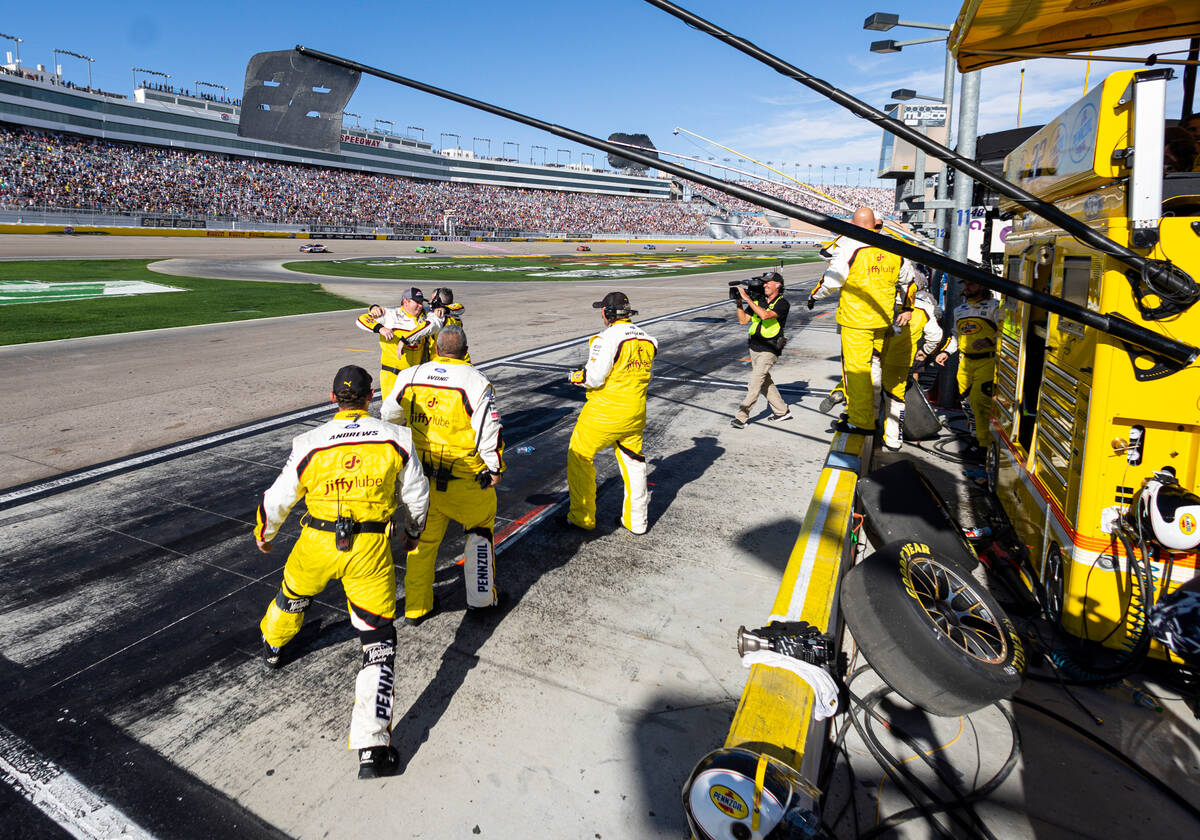 Members of driver Joey Logano’s pit crew celebrate as he wins the South Point 400 NASCAR ...