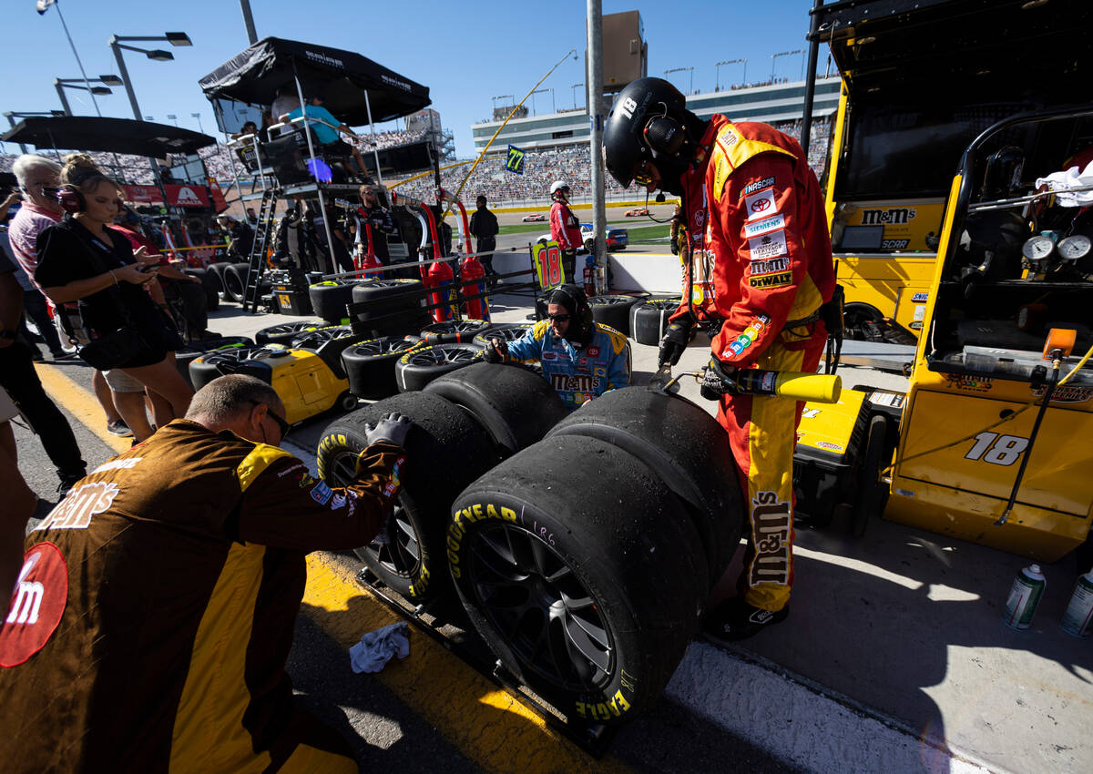 Pit crew members of driver Kyle Busch work the tires after a pit stop during the South Point 40 ...