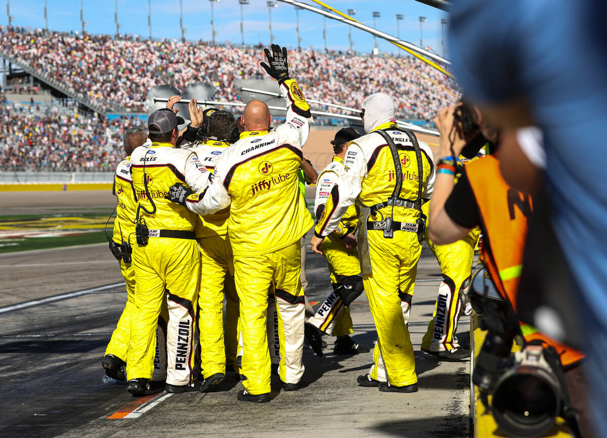 Members of driver Joey Logano’s pit crew celebrate as he wins the South Point 400 NASCAR ...