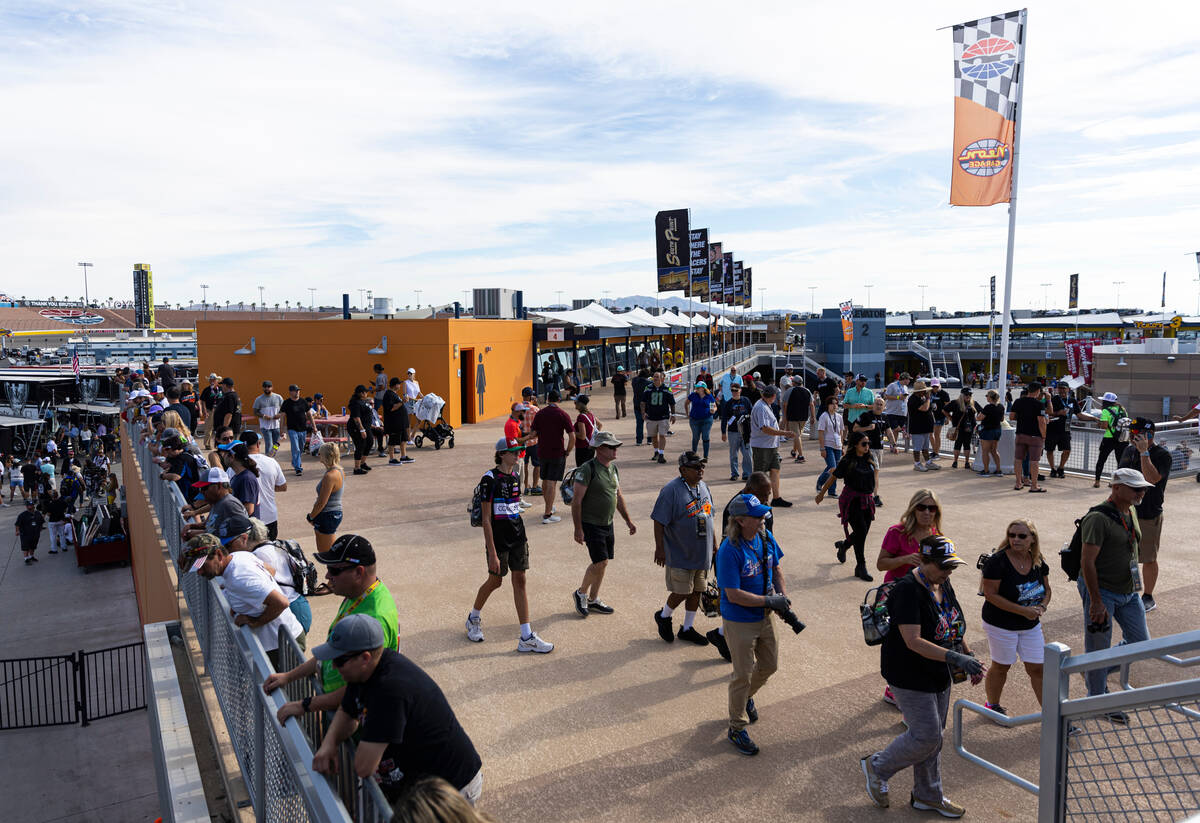 People walk around the Neon Garage area before the NASCAR Cup Series playoff race at Las Vegas ...