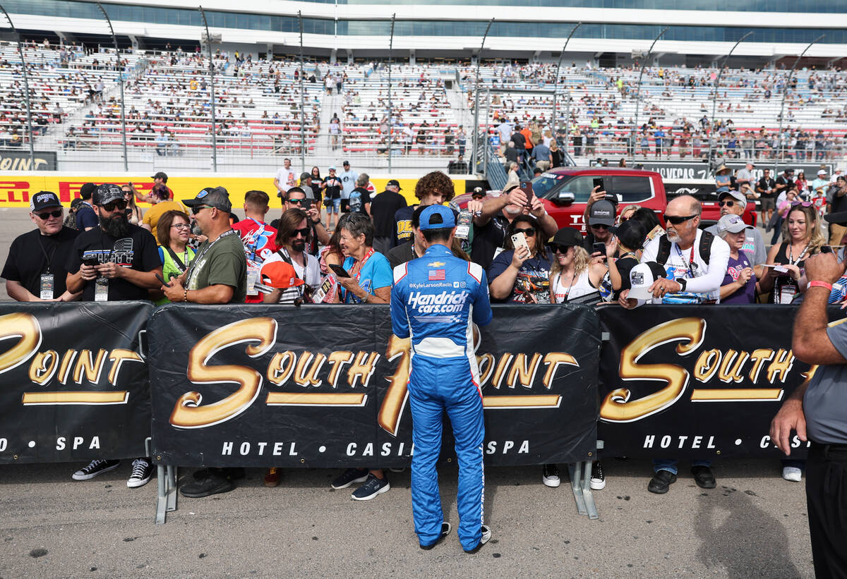 Driver Kyle Larson (5) signs autographs for fans before the NASCAR Cup Series playoff race at L ...