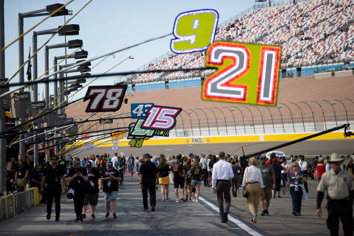 Race fans walk pit road before the South Point 400 NASCAR Cup Series playoff race at Las Vegas ...