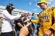 Honorary pace car driver Davante Adams of the Raiders, left, greets driver Kyle Busch before th ...