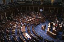 In this image from video, members of the House practice social distancing as they sit on the fl ...