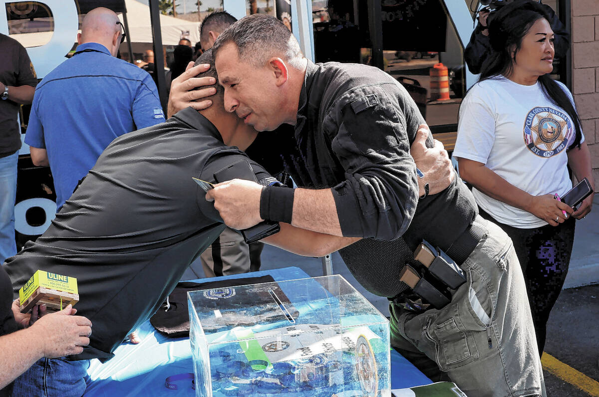 Las Vegas police officer Sal Mascoli, right, hugs Sgt. Charles “JP” Jivapong duri ...