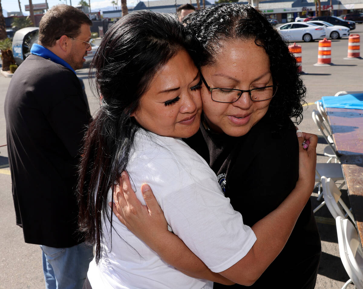 Angela Thai, ex-wife of fallen Las Vegas police officer Truong Thai, right, hugs Injured Police ...