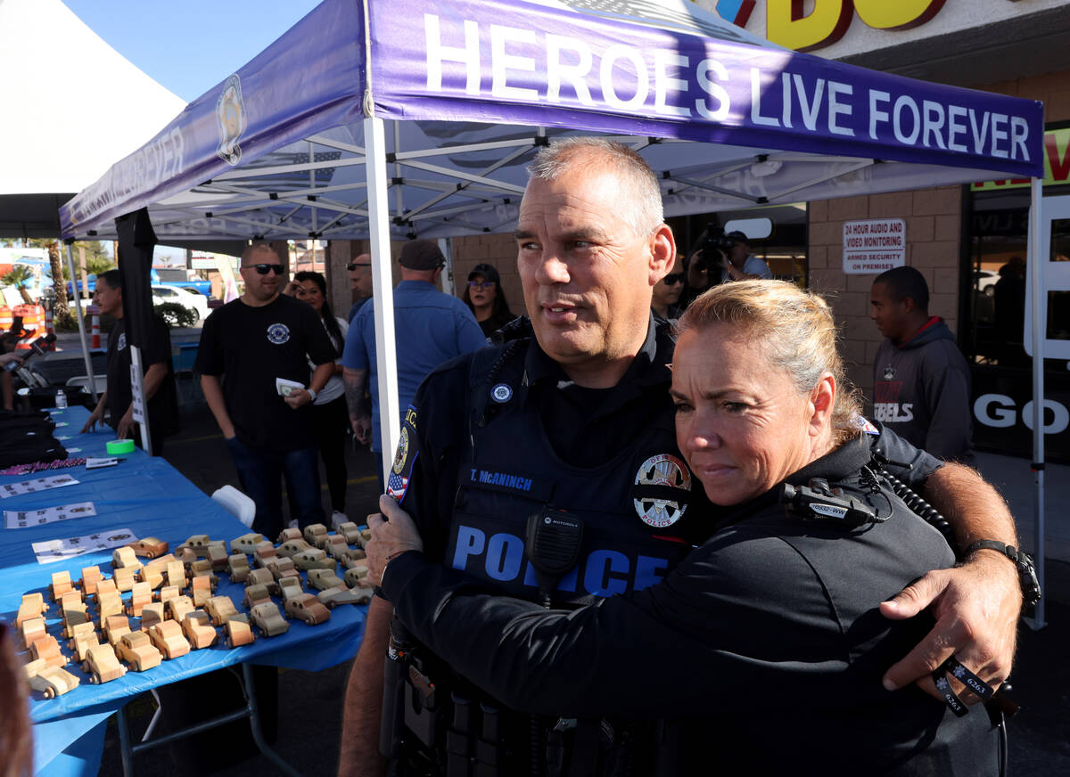 Clark County School District Police Department officer Terry McAninch gets a hug from Deborah R ...