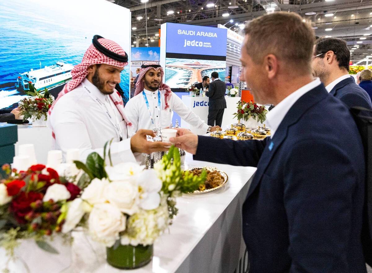 Saad Alathbah, left, a JEDCO representative, serves coffee to Leif Moland, right, at Jaddah, Sa ...