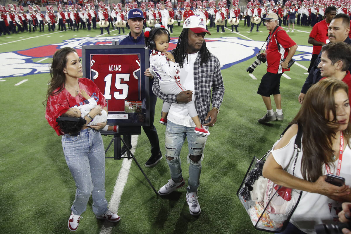 Las Vegas Raiders' Davante Adams, center, a former Fresno State player, has his jersey number r ...