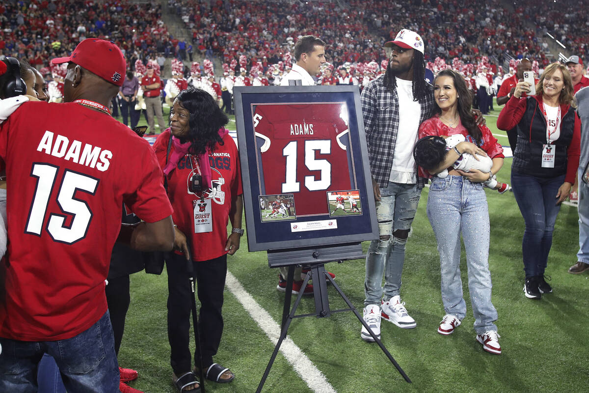 Las Vegas Raiders' Davante Adams, center right, a former Fresno State player, has his jersey nu ...