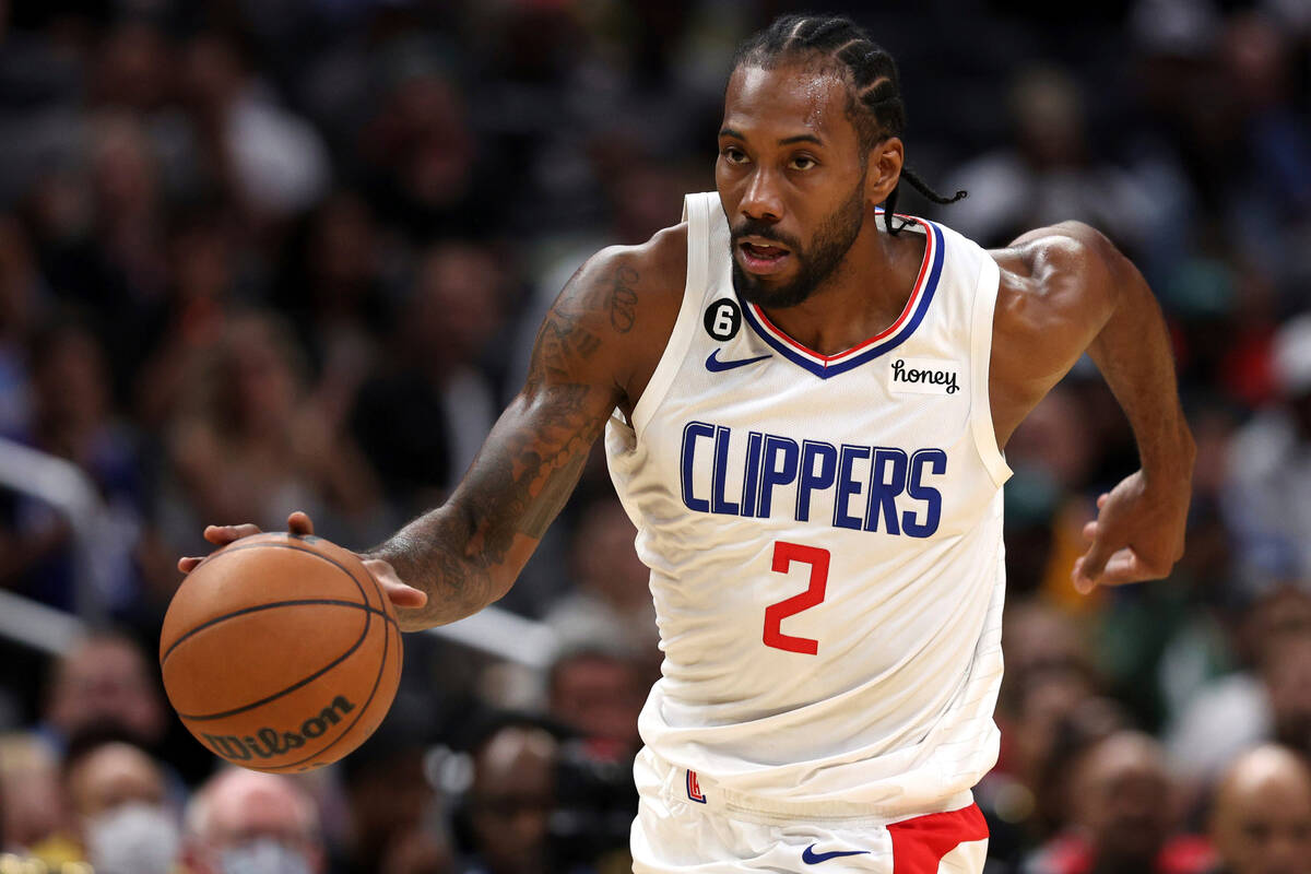 Los Angeles Clippers forward Kawhi Leonard dribbles down the court during the first half of a p ...