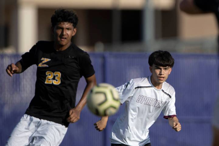 Cimarron-Memorial’s Miguel Pina, right, passes to a teammate while Durango’s Donovan Rangel ...