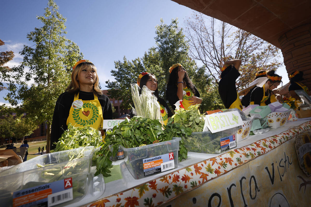 Sierra Vista High School student Cassandra Manreal, 15, left, sells products on Thursday, Oct. ...
