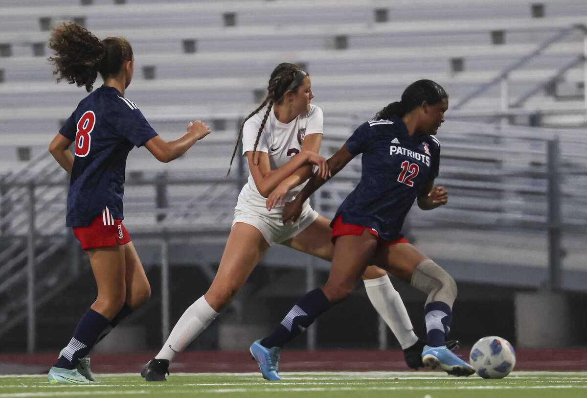 Desert Oasis' Kate Perkes (2) tries to get the ball from Liberty's Danica Key (12) during a soc ...