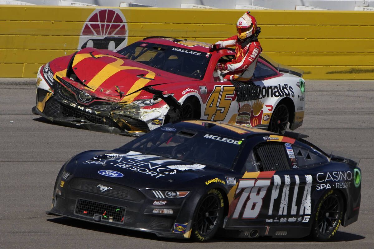Bubba Wallace gets out of his car after crashing during a NASCAR Cup Series auto race Sunday, O ...