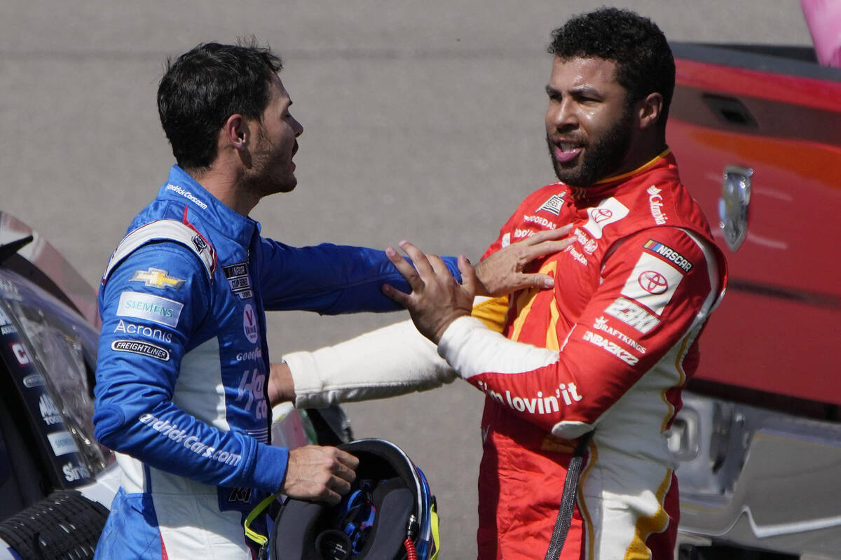 Bubba Wallace, right, and Kyle Larson push each other away after the two crashed during a NASCA ...