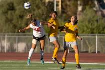 Doral Academy’s Gianna Davis (20) jumps to head the ball alongside Bonanza’s Mayr ...