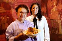 Lotus of Siam owner/chef Saipin Chutima, left, shows a dish of Garlic Prawns with her daughter ...