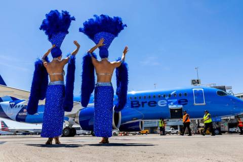 Showgirls Brooke, left, and Tara welcome passengers for the Breeze Airways inaugural flight arr ...