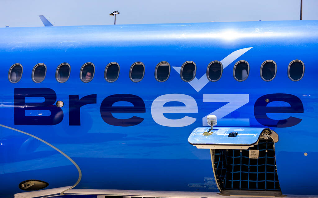 A Breeze Airways passenger looks out the window as their inaugural flight arrival makes it to t ...