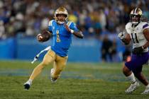 UCLA quarterback Dorian Thompson-Robinson (1) runs against Washington during the first half of ...