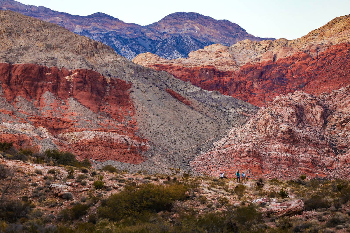Hikers walk a trail in Calico Basin on the eastern edge of the Red Rock Canyon National Conserv ...