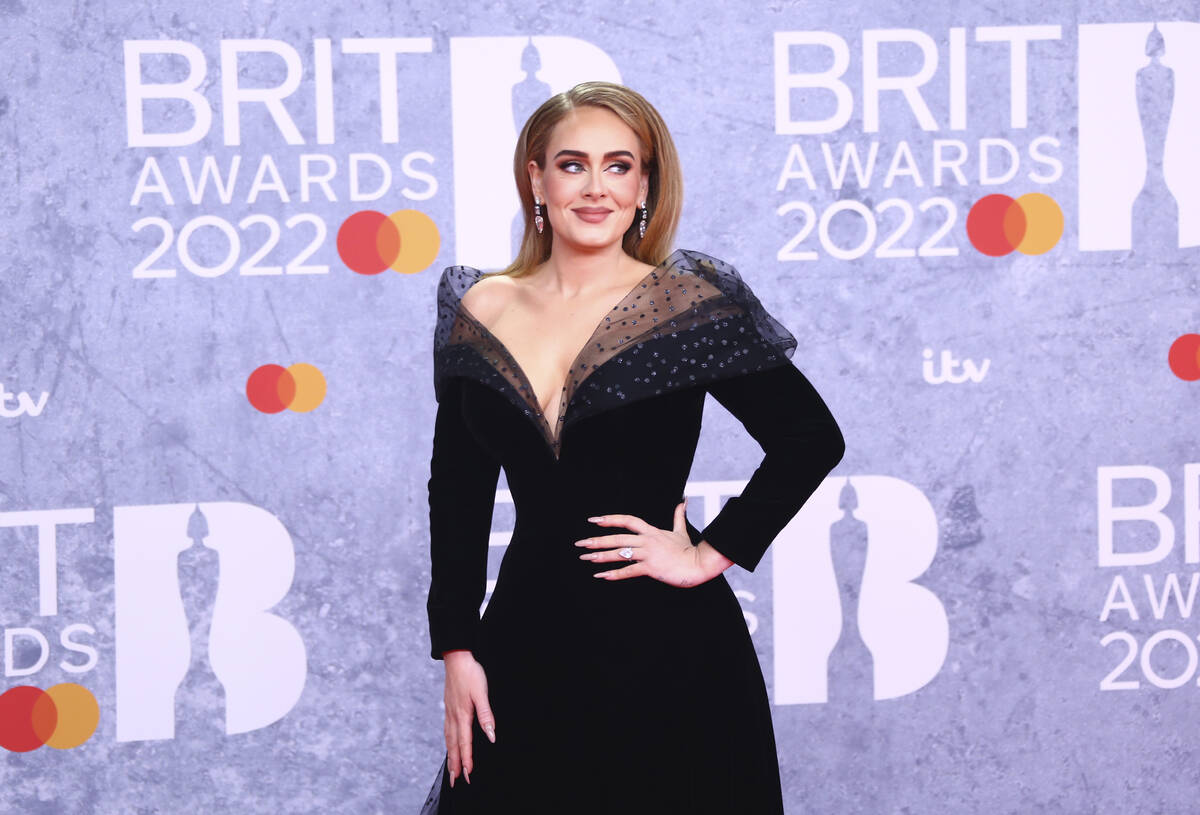 FILE - Adele poses for photographers upon arrival at the Brit Awards 2022 in London Tuesday, Fe ...