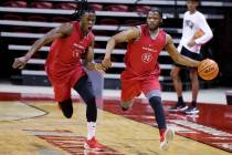 UNLV’s EJ Harkless, 55, moves the ball past Victor Iwuakor, 0, during practice at Thomas ...