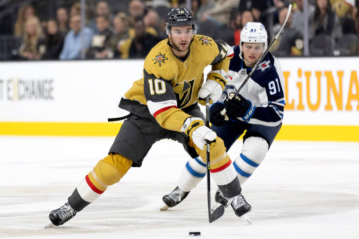 Golden Knights center Nicolas Roy (10) skates against Jets center Cole Perfetti (91) during the ...