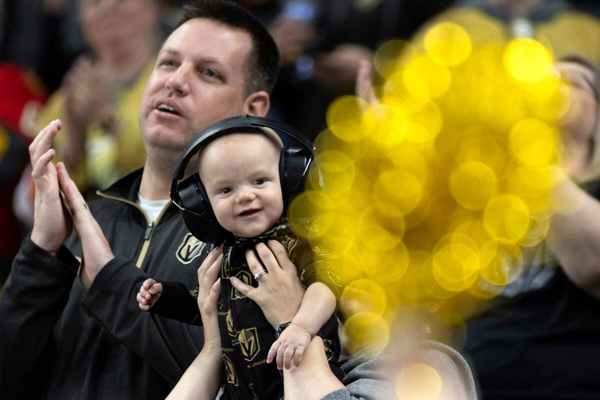 A young Golden Knights fan is entertained by a pompom during the third period of an NHL hockey ...