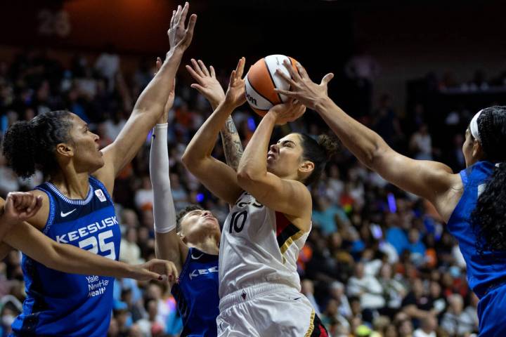 Las Vegas Aces guard Kelsey Plum (10) shoots against Connecticut Sun forward Alyssa Thomas (25) ...