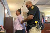 Daysia Brown, 25, is being walked out of court on Thursday, Oct. 20, 2022, in Las Vegas, after ...