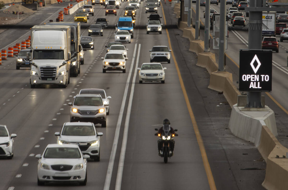 An HOV lane sign denotes that the lane is "open to all" as part of a pilot transporta ...