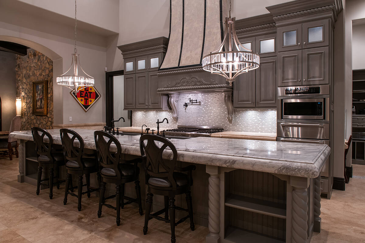 The kitchen has a large island with seating. (Simply Vegas)