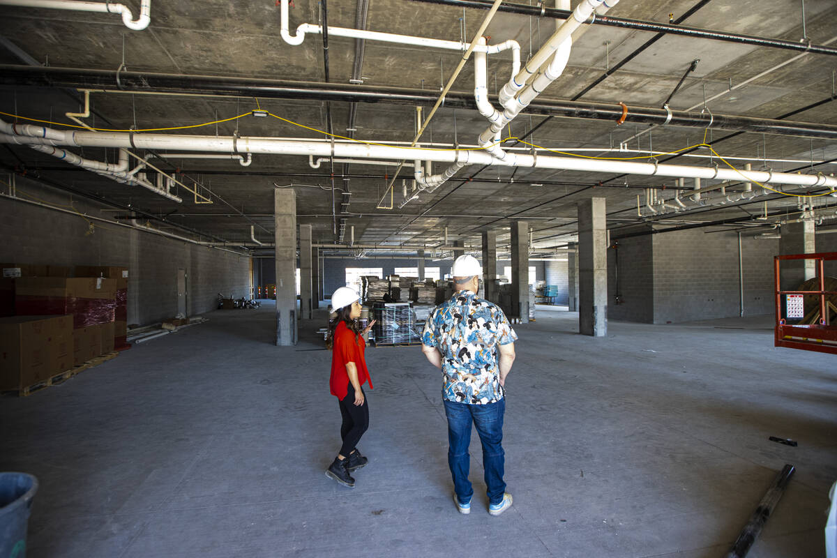Tiffany Brown, property manager at ShareDOWNTOWN, left, gives a tour to a prospective tenant at ...
