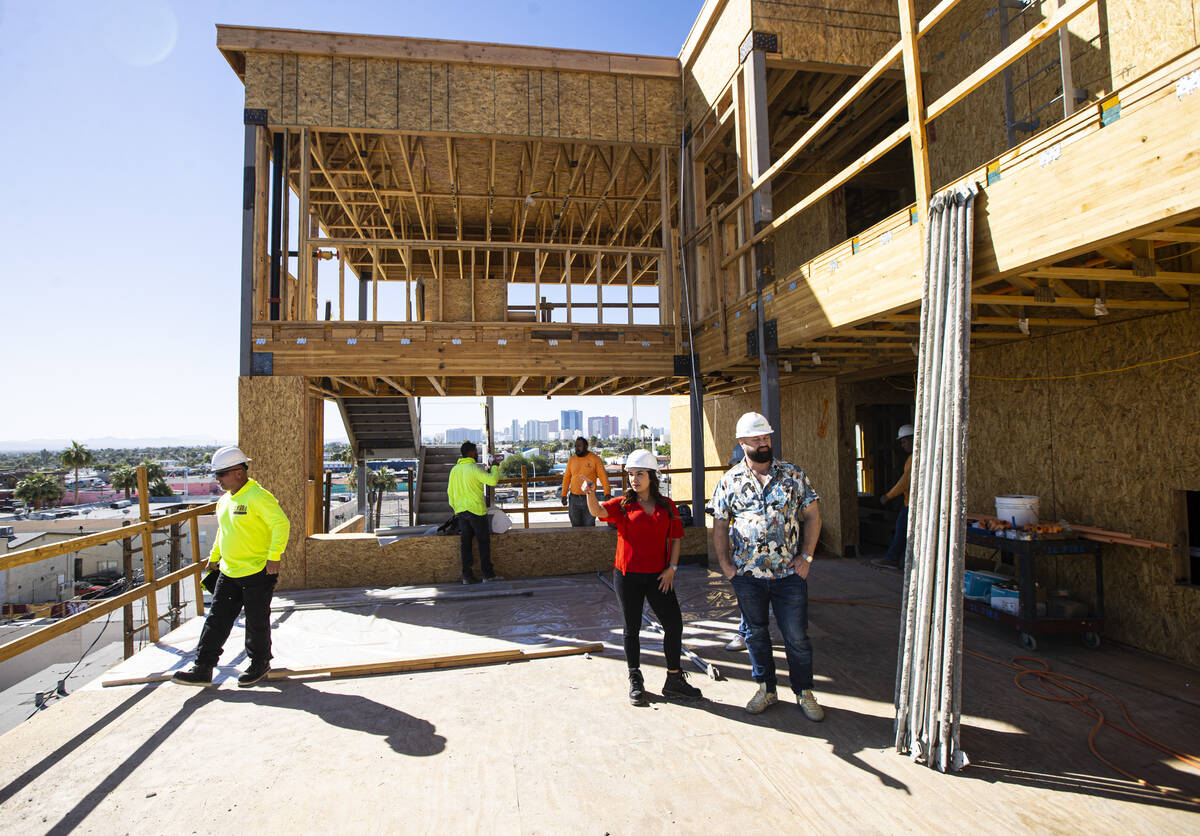 Tiffany Brown, property manager at ShareDOWNTOWN, right, in red, points out the views from the ...