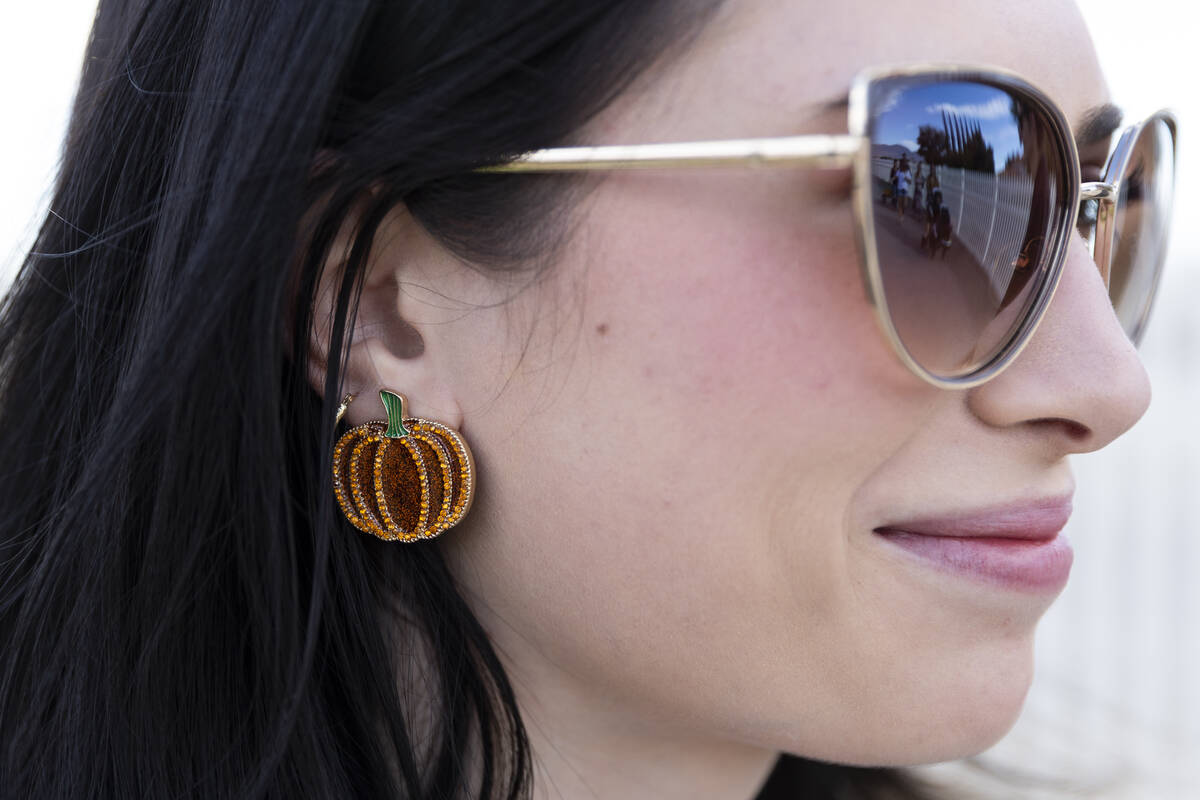 Summer Hall shows off her pumpkin earrings while visiting Gilcrease Orchard in Las Vegas, Thurs ...
