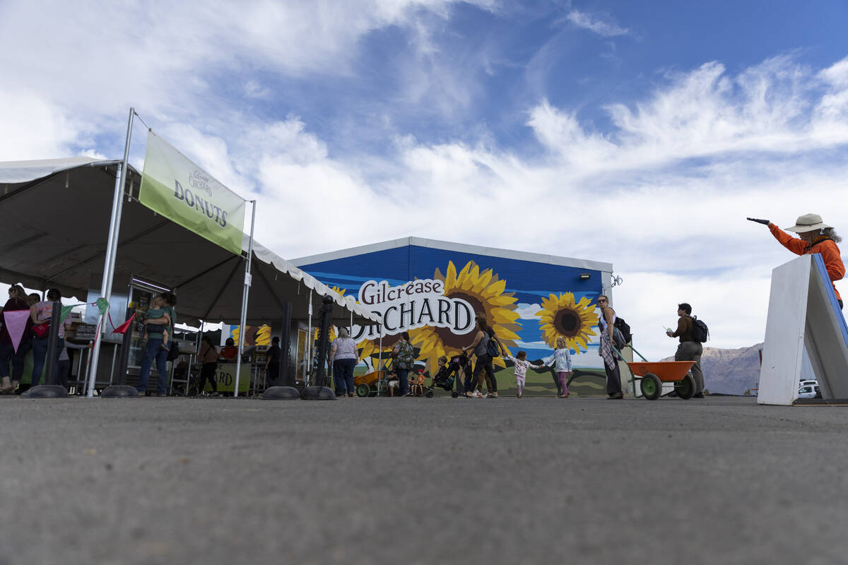 People visit the donut stand at Gilcrease Orchard in Las Vegas, Thursday, Oct. 20, 2022. (Erik ...