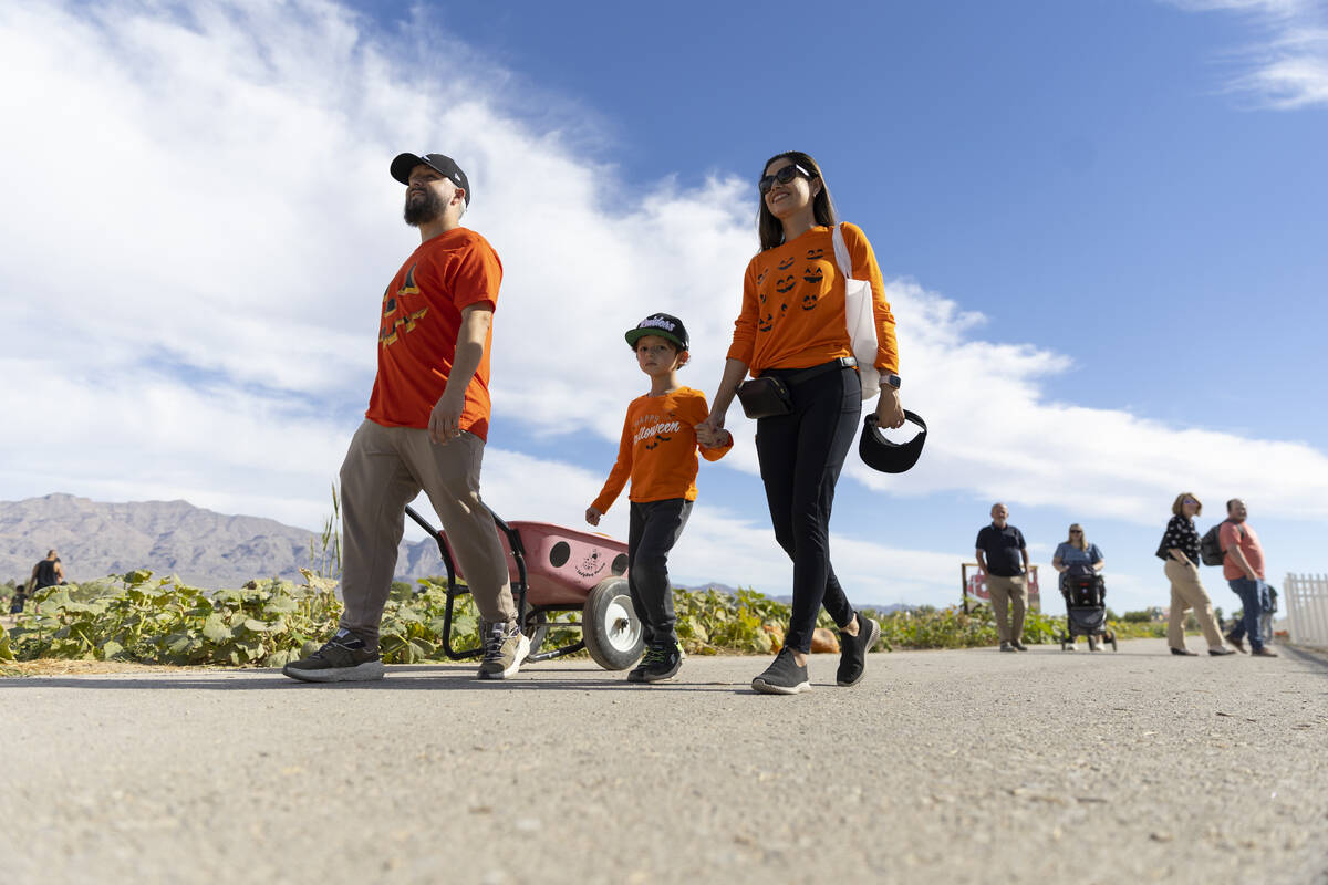 Jhobany Escalante, from left, with his son Owen, 4, and wife Carina, visit Gilcrease Orchard in ...