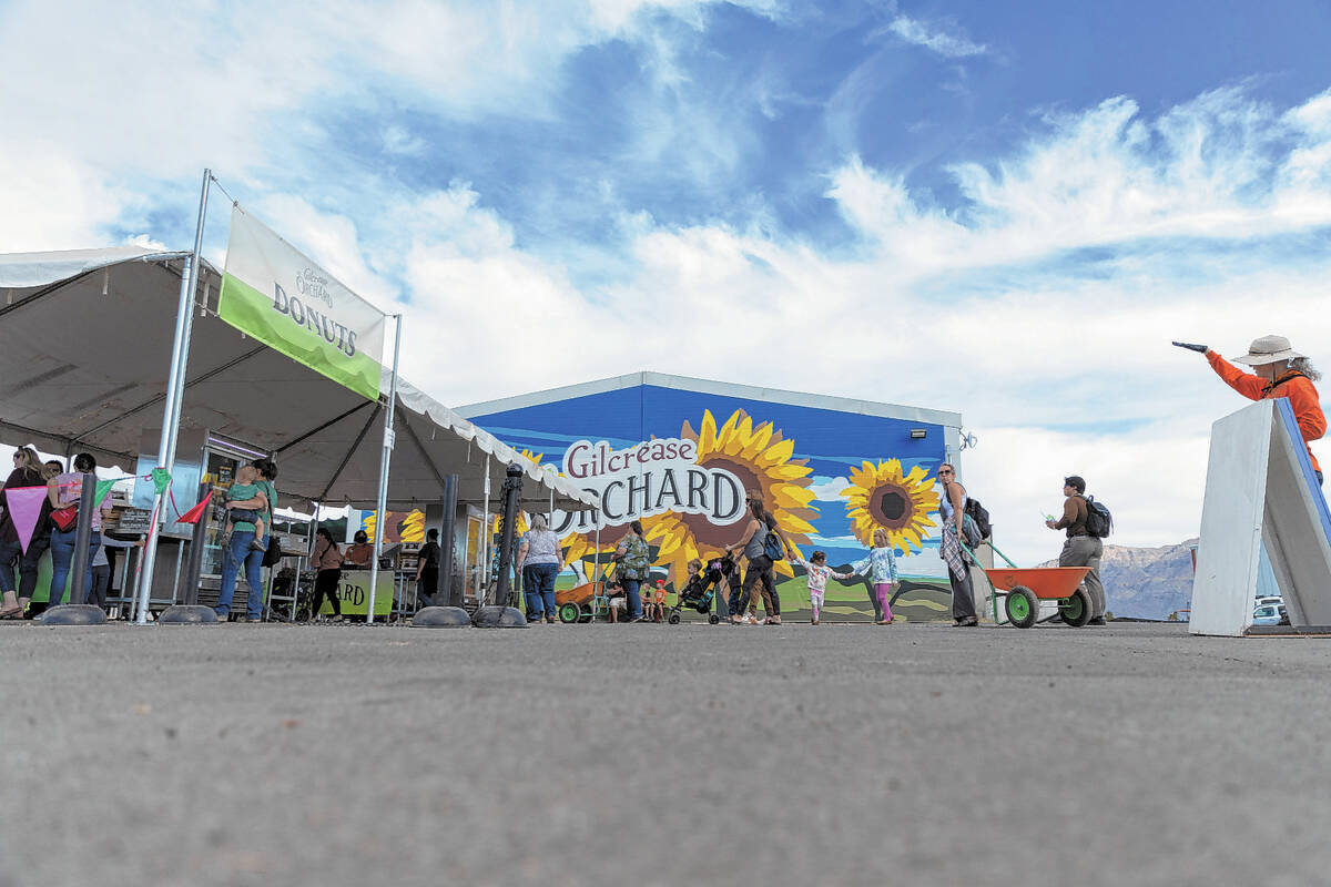 People visit the donut stand at Gilcrease Orchard in Las Vegas, Thursday, Oct. 20, 2022. (Erik ...