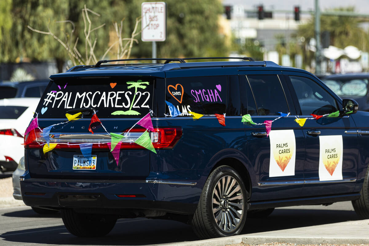An SUV is decorated for Palms Cares upon arrival at Green Our Planet’s student farmers m ...