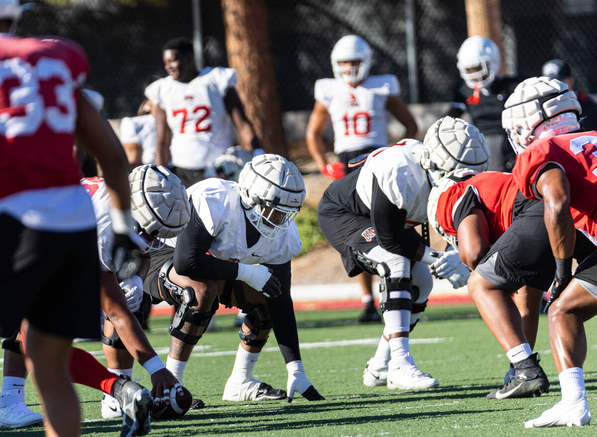 UNLV offensive linemen Preston Nichols, center left, and Daviyon McDaniel, right, participate d ...