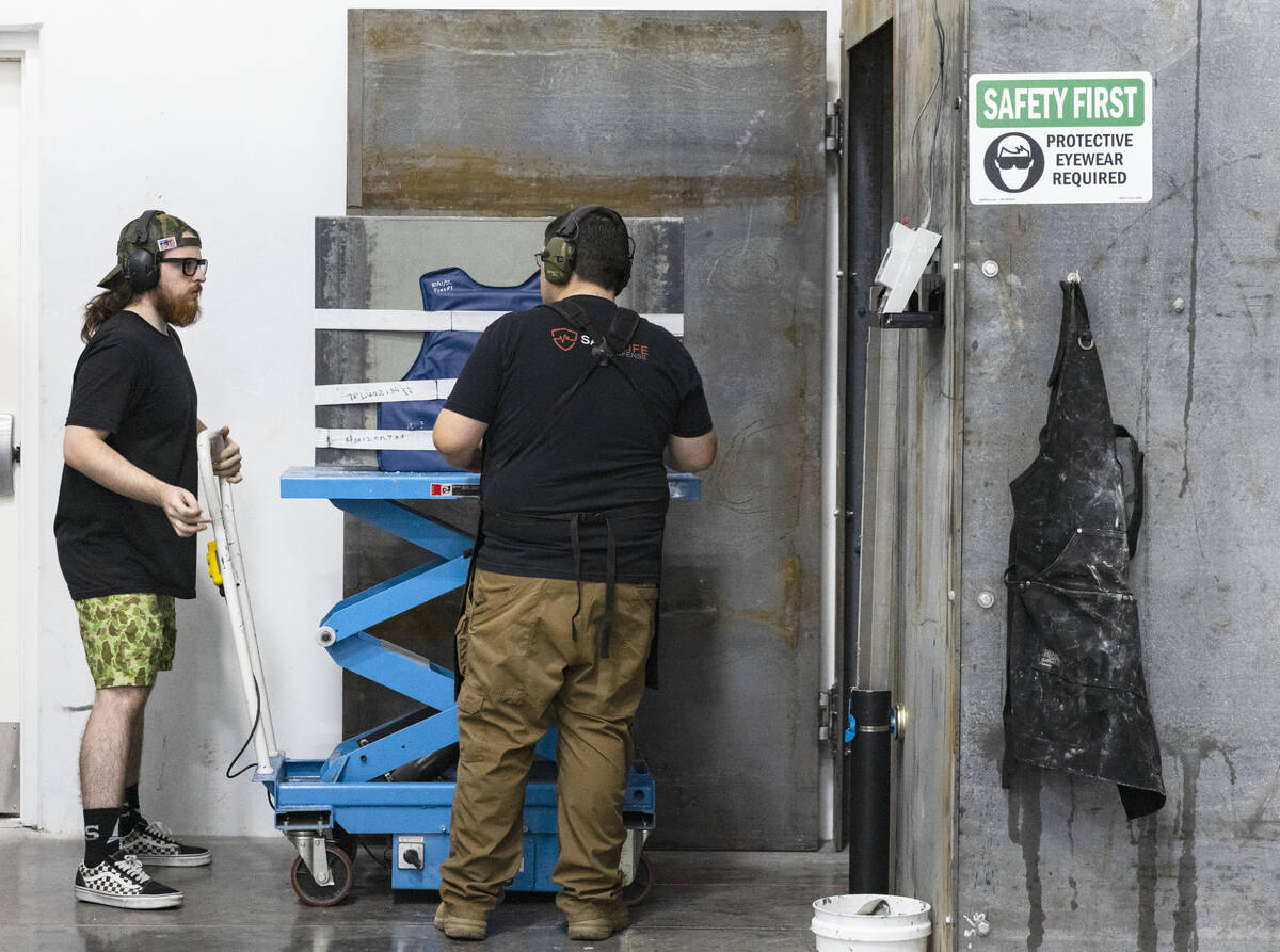A ballistic impact lab operator, left, and operation manager at Safe Life Defense, who declined ...