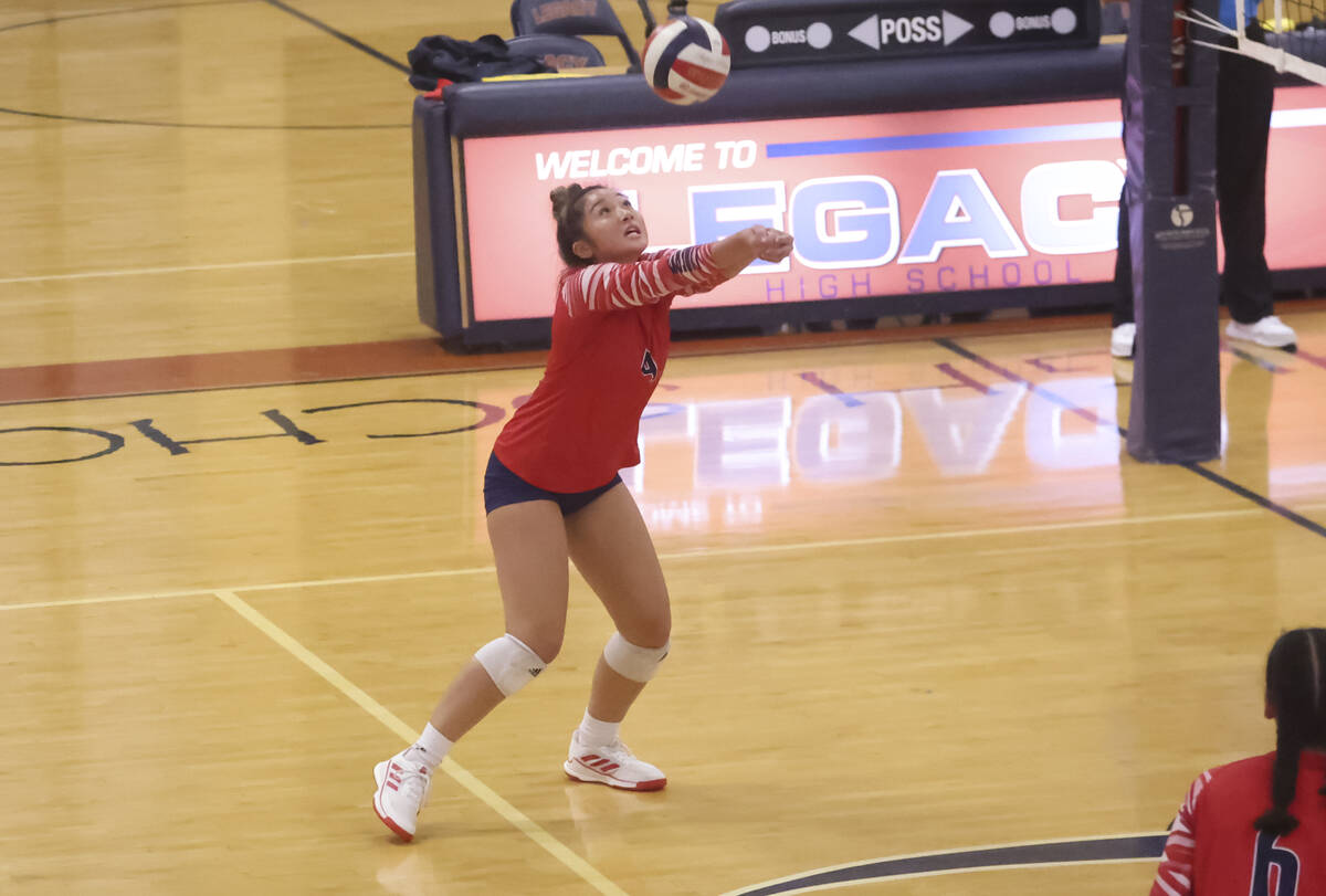 Liberty's Mike Yamamota (4) sets the ball during a volleyball game at Legacy High School on Thu ...