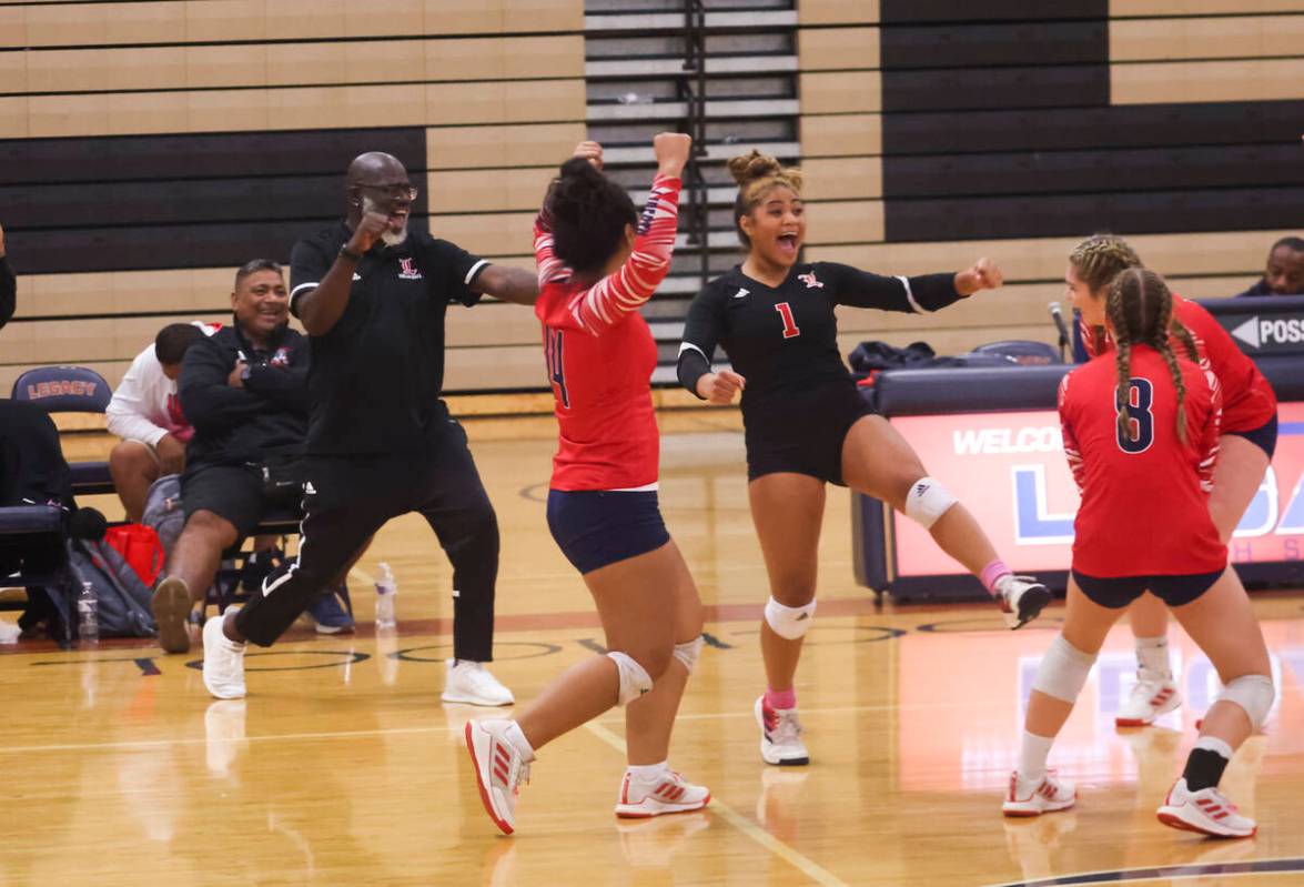 Liberty players celebrate after defeating Legacy in a volleyball game at Legacy High School on ...